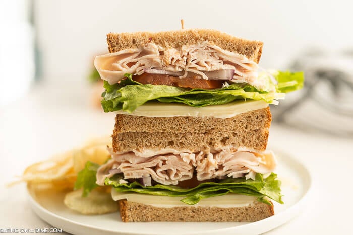 Close up of  turkey sandwich sliced in half. 