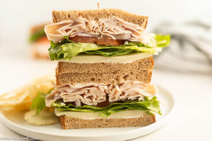 Close up of  turkey sandwich sliced in half. 