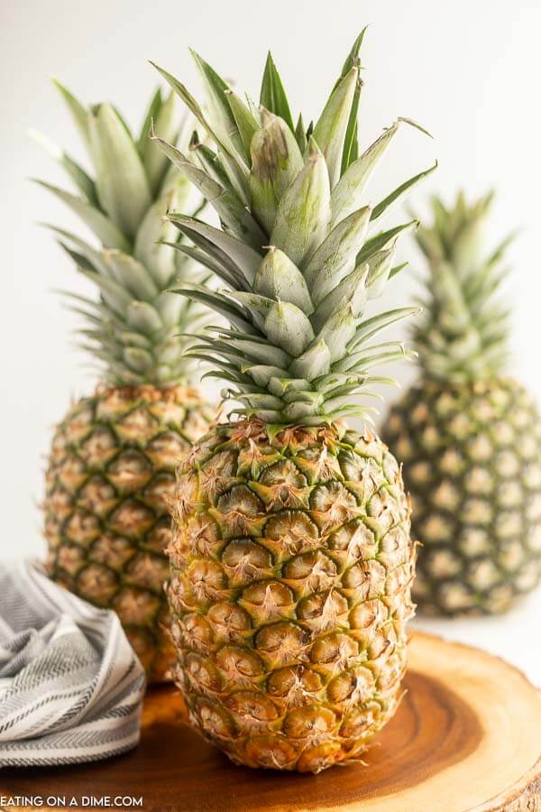 Close up image of 3 pineapples. 