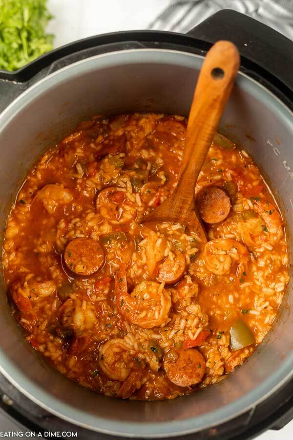 Jambalaya in the instant pot with a wooden spoon 