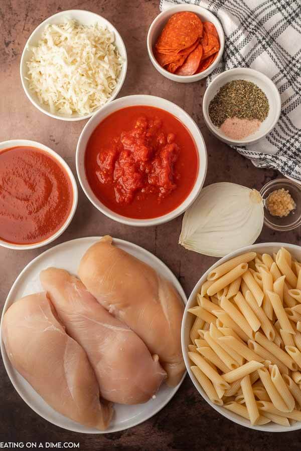 Ingredients needed - chicken, pepperonis, diced tomatoes, onion, water, tomato sauce, salt and pepper, italian seasoning, garlic salt, pasta, mozzarella cheese