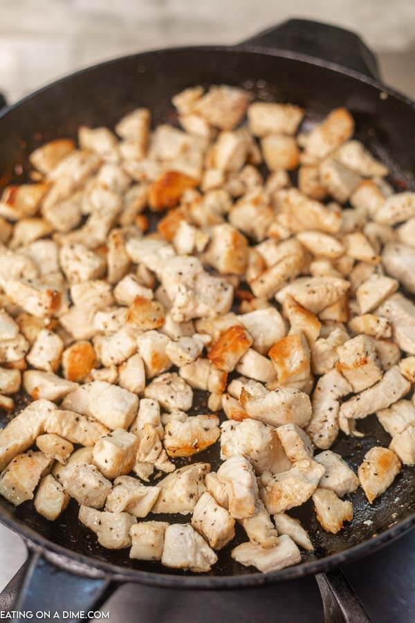 Close up image of cooked chicken in an iron skillet. 