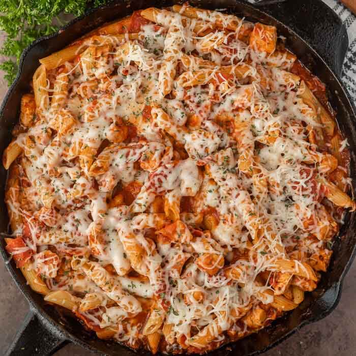 Close up image of Chicken Pepperoni Pasta in an iron skillet. 