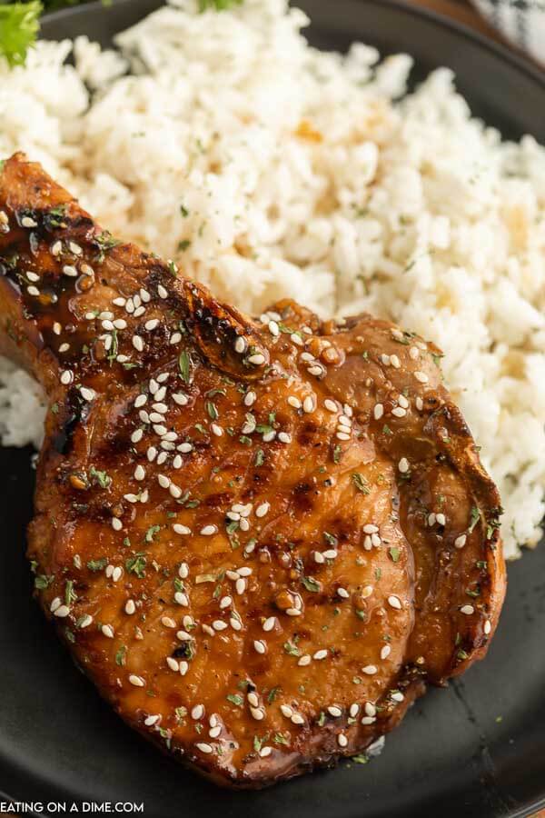 Grilled teriyaki pork chops on a plate with rice. 