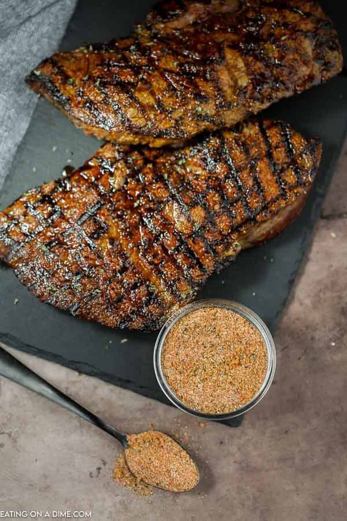 Texas Roadhouse Steak Seasoning beside steaks.