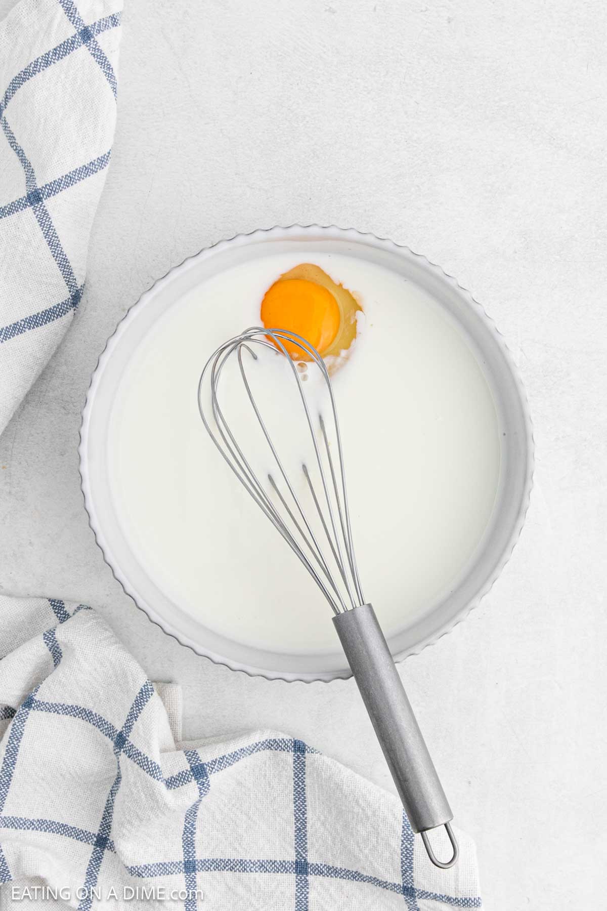 Whisk milk and egg together in a bowl