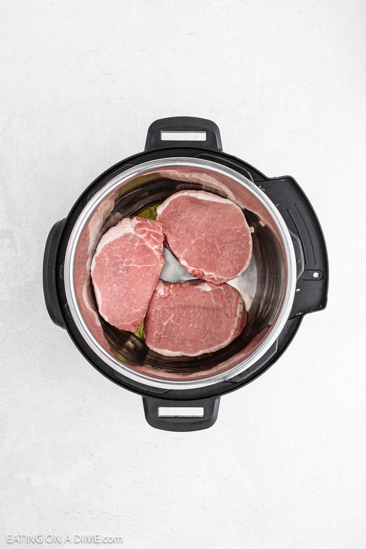 Uncooked pork chops in the instant pot.