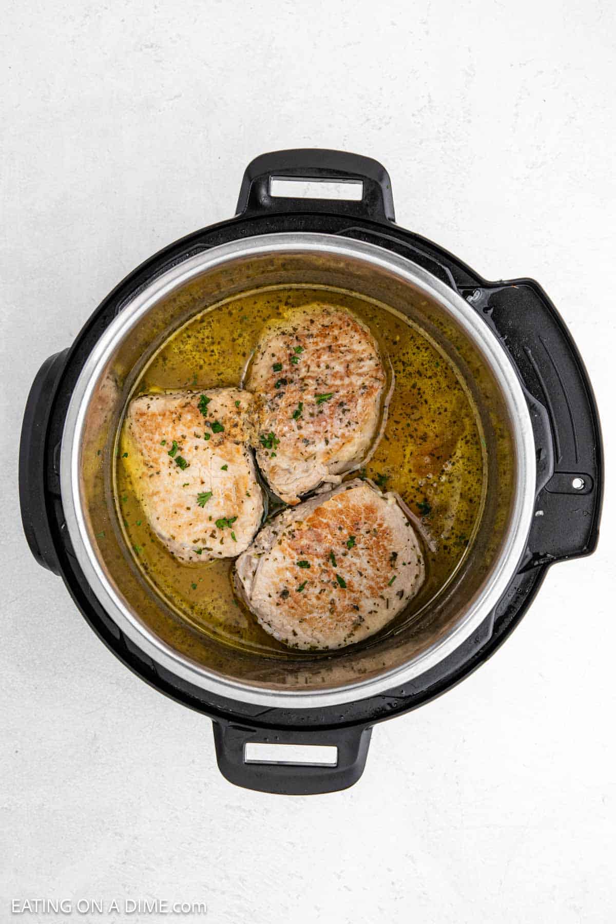 Cooked pork chops in the instant pot in sauce.
