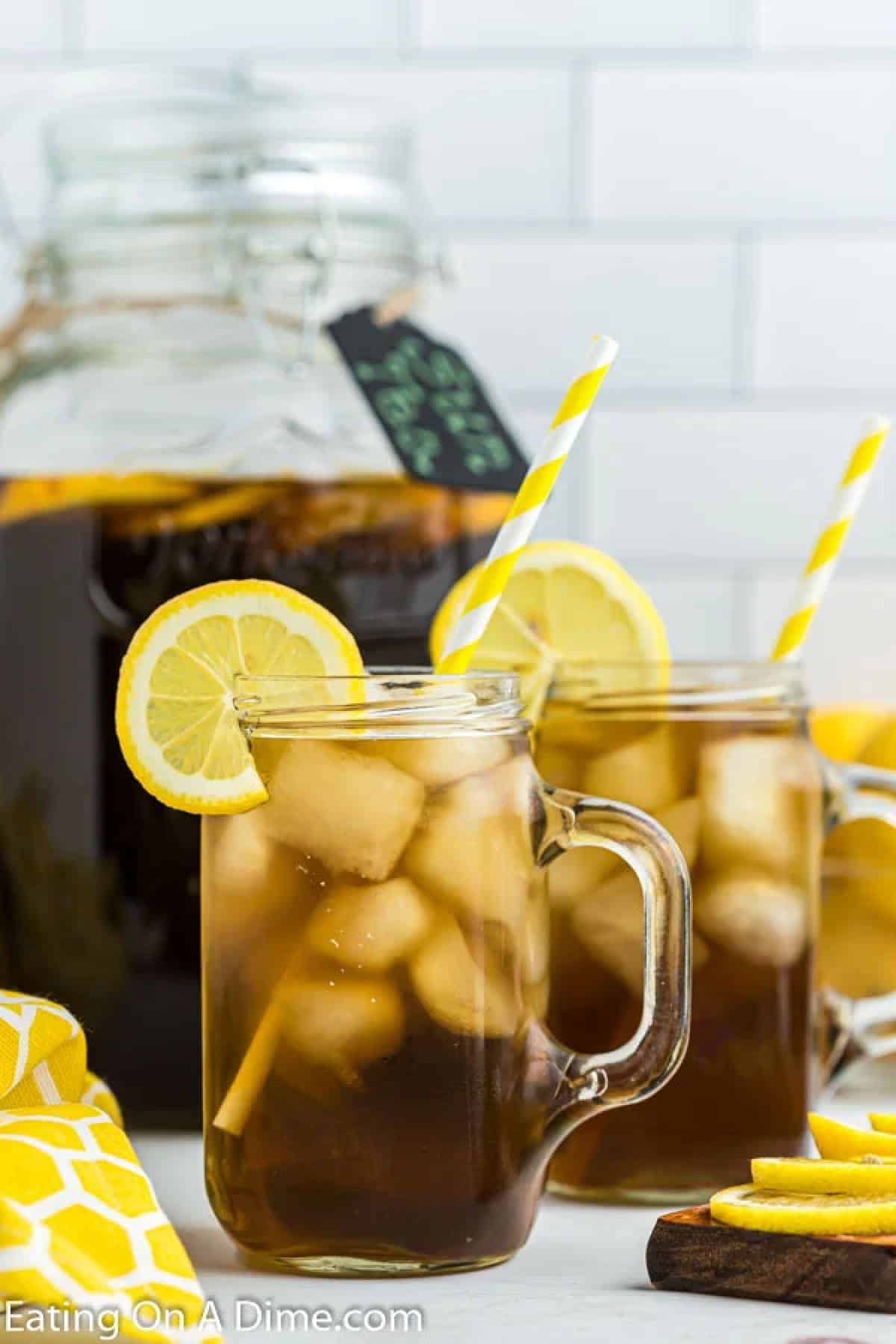 Close up image of two glass with tea and a slice of lemon on the side. 