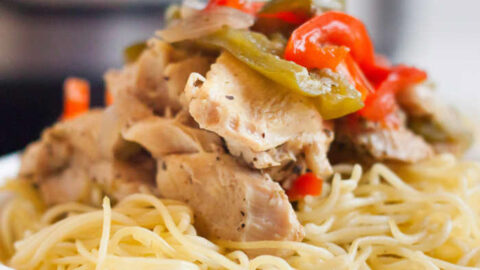 Close up image of a bowl of chicken scampi over pasta.