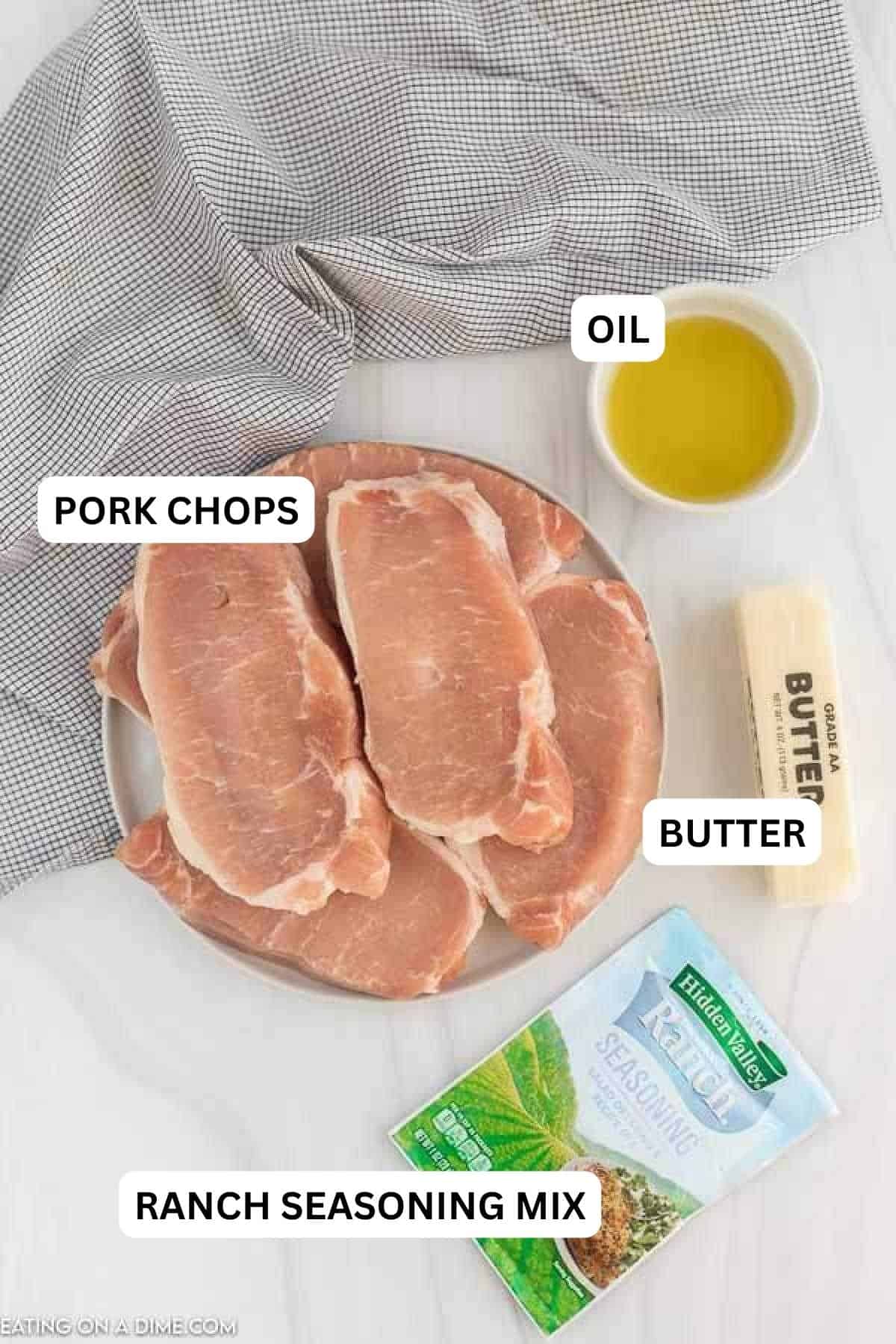 Ingredients needed to make this recipe which includes olive oil, pork chops, butter, ranch seasoning mix, and water.