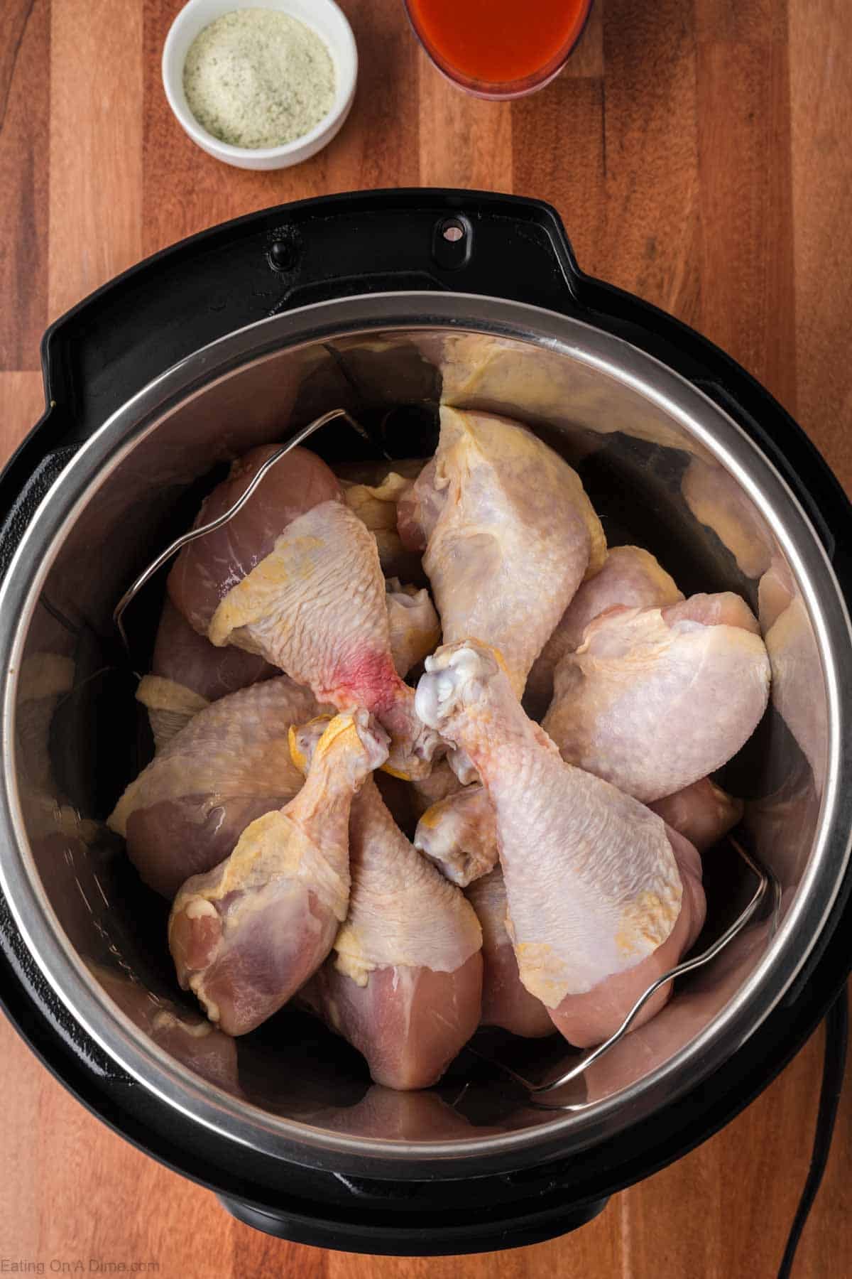 Raw chicken legs placed in the instant pot