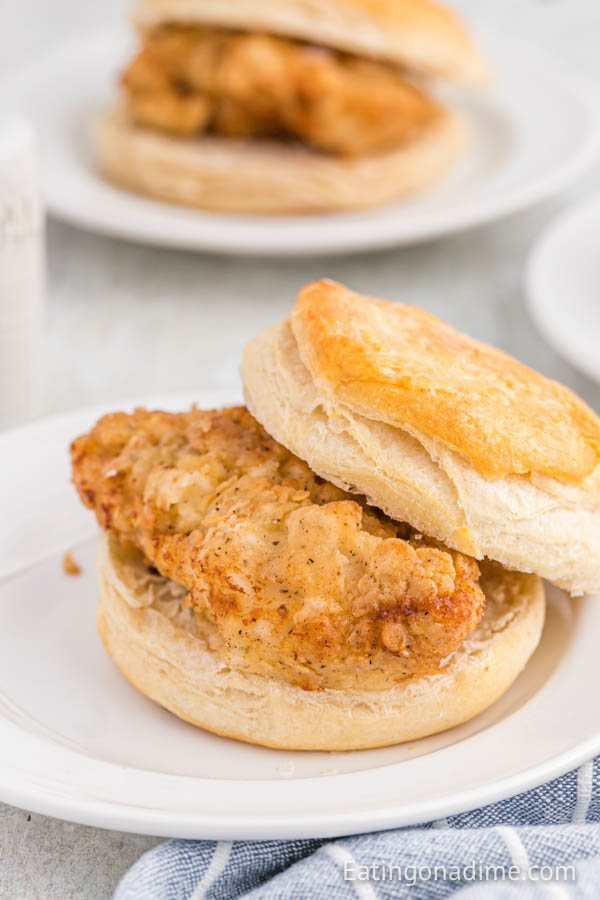 Close up image of chicken biscuit on a white plate. 