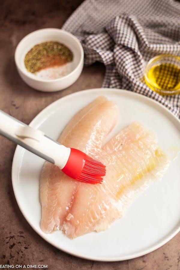 Tilapia being based with oil. 