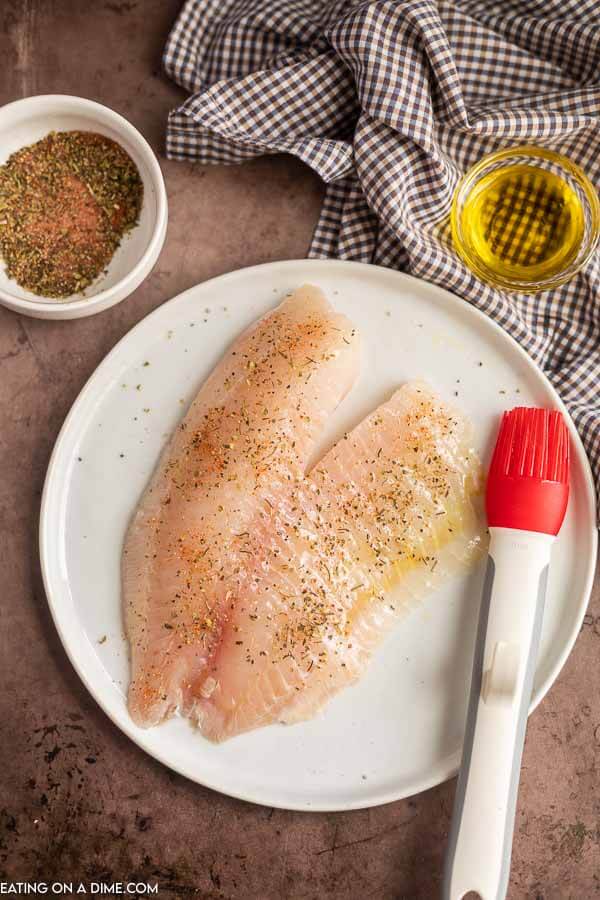 Tilapia being seasoned. 