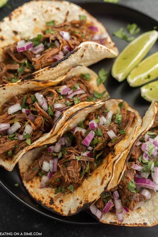 Slow cooker barbacoa tacos on a plate. 