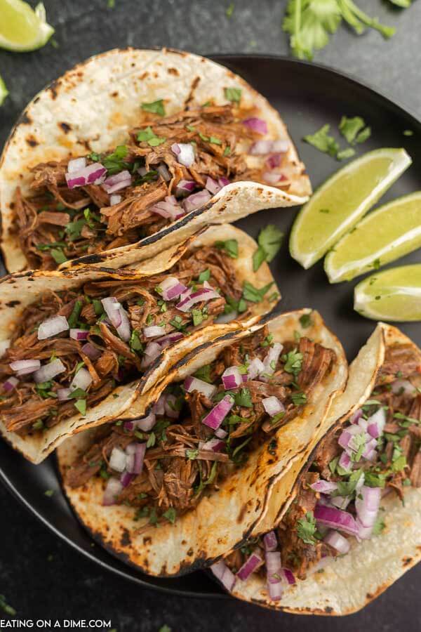Slow cooker barbacoa tacos on a plate. 