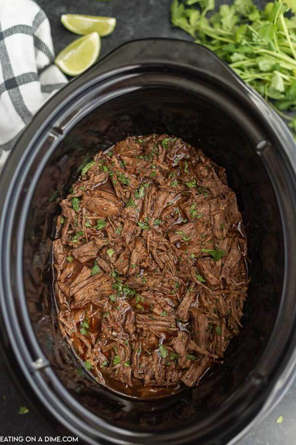 Slow cooker barbacoa beef shredded in crock pot. 