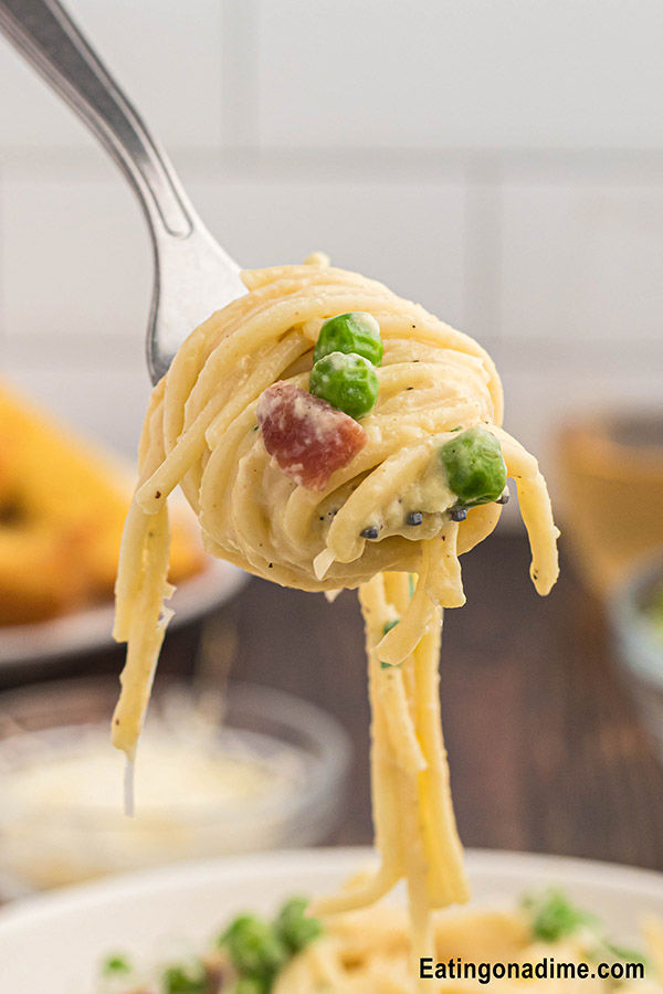 Closeup photo of Cheesecake factory pasta carbonara on a fork. 