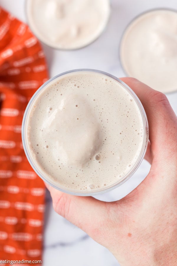 Holding a frosty in a glass