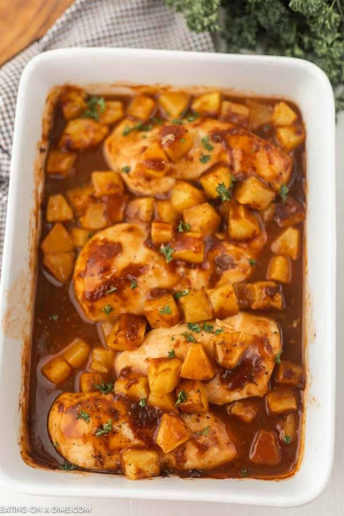 Baked Pineapple BBQ chicken recipe is the perfect meal idea and only requires 3 ingredients. It is so easy but tastes like you spent all day cooking. Baked BBQ Pineapple chicken on a plate with a side of rice.