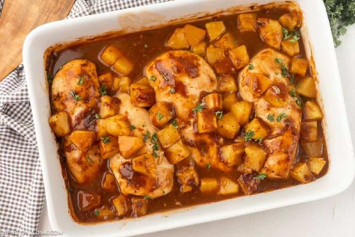 Baked Pineapple BBQ chicken recipe is the perfect meal idea and only requires 3 ingredients. It is so easy but tastes like you spent all day cooking. Close up image of chicken in a casserole dish.