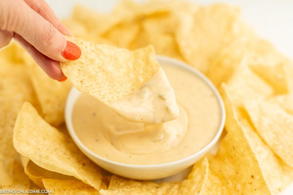 Close up image of queso in a bowl with a side of chips