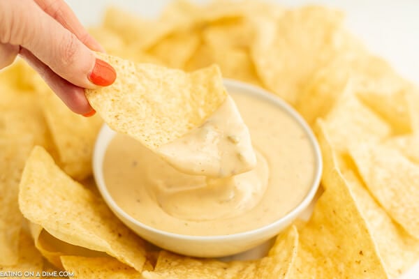 Close up image of queso in a bowl with a side of chips