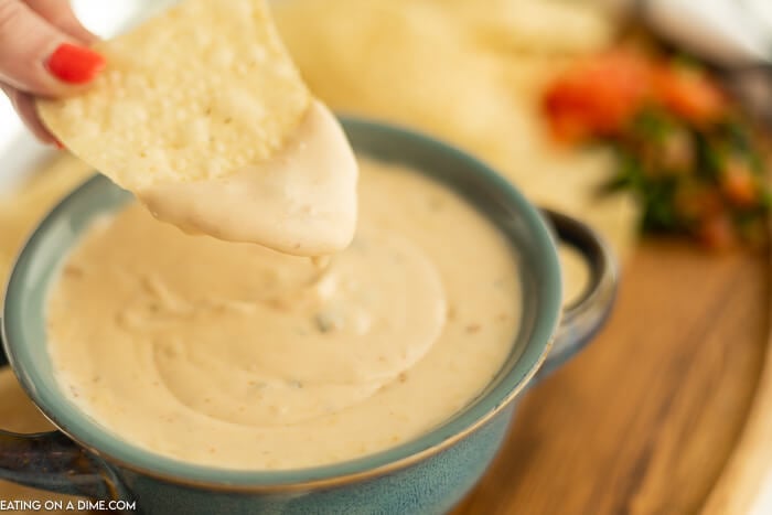 Close up image of queso in a bowl with a side of chips