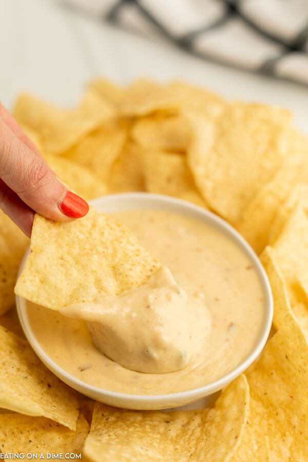 Close up image of queso in a bowl with a side of chips