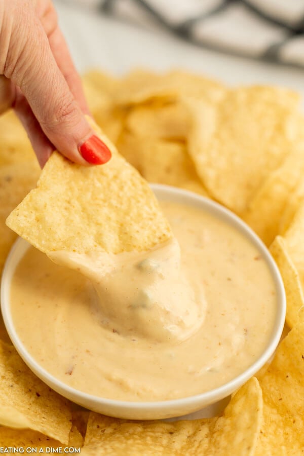 Close up image of queso in a bowl with a side of chips