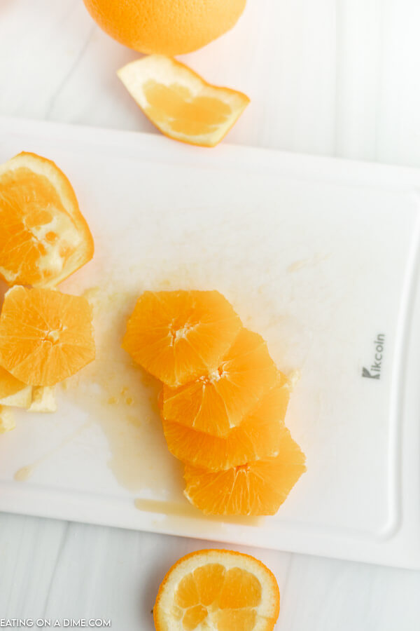 Close up image of orange slices on a cutting board. 