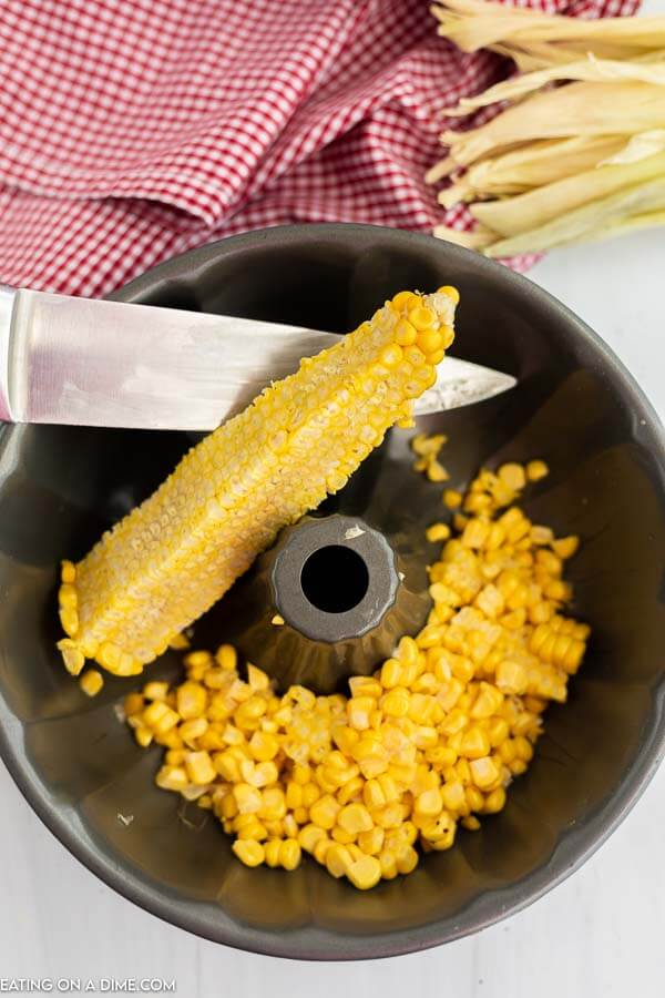 Close up image of corn on the cob and corn kernels in a bundt pan