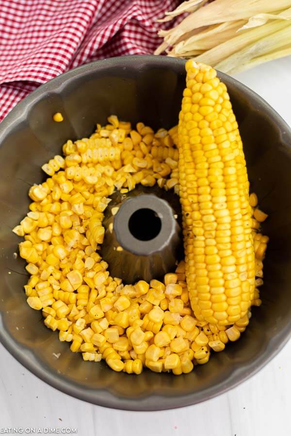 Close up image of corn on the cob and corn kernels in a bundt pan