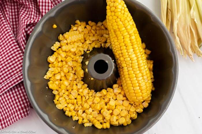 Close up image of corn on the cob and kernels in a bundt pan. 