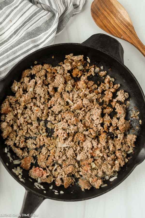 Close up image of frying the ground beef in a cast iron skillet. 