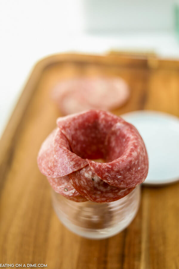 Slices of salami on a wine glass