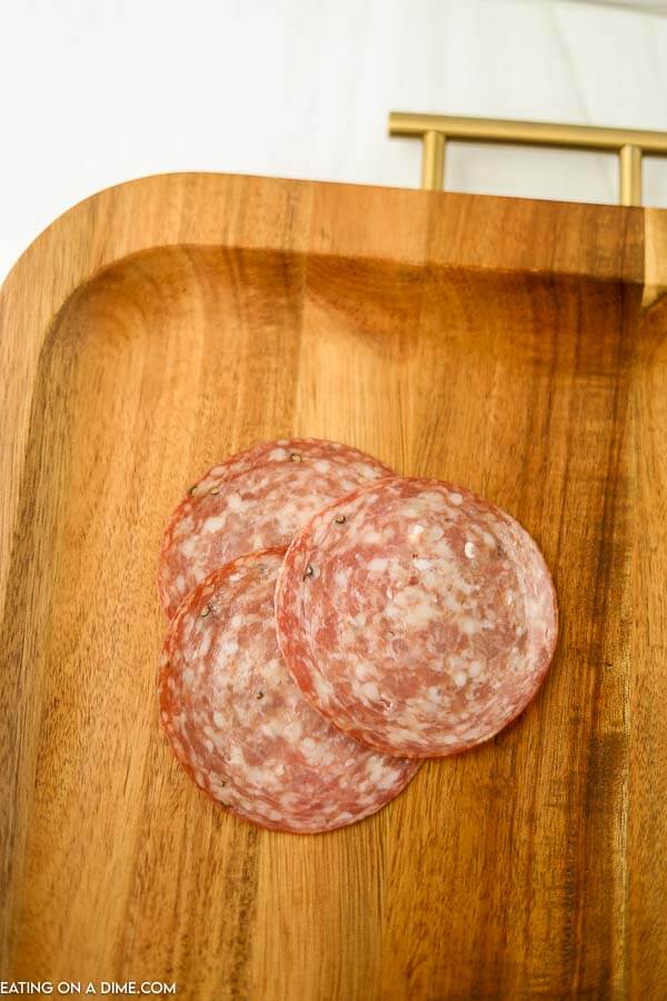 Three slices of salami on a board