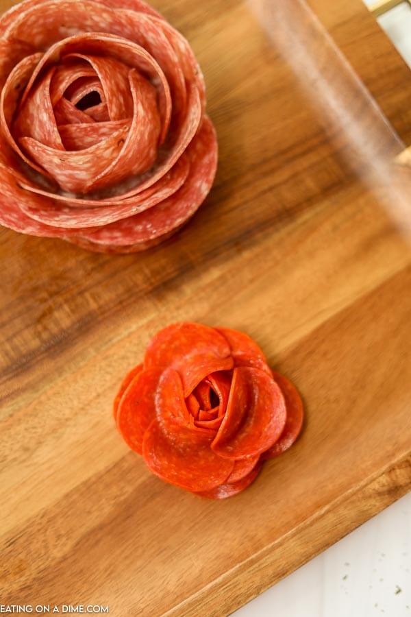 Close up image of salami rose and a pepperoni rose