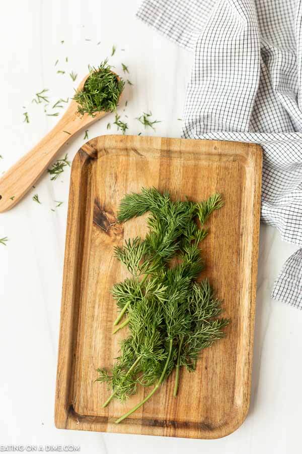 Close up image of fresh dill on a cutting board