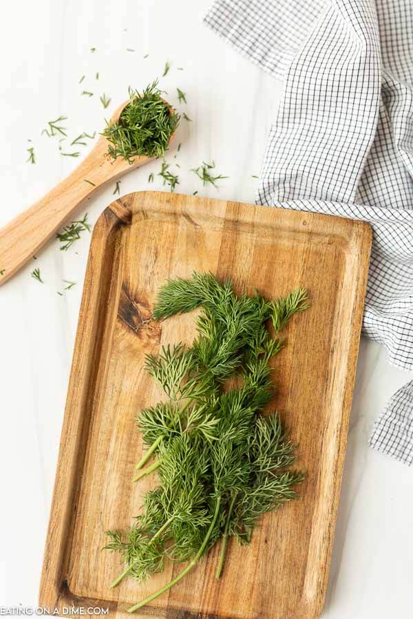 Close up image of fresh dill on a cutting board