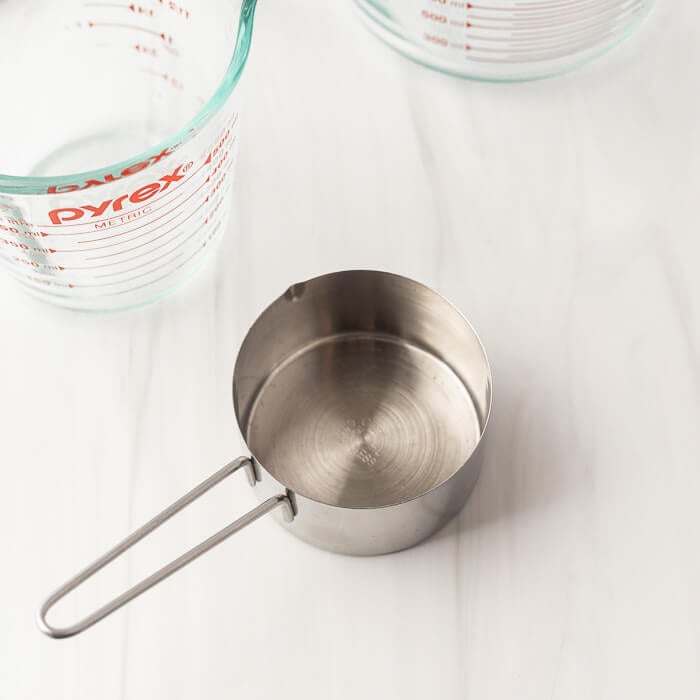 Close up image of a measuring cup and two liquid measuring cups. 