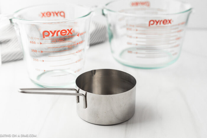 Close up image of a measuring cup and two liquid measuring cups. 