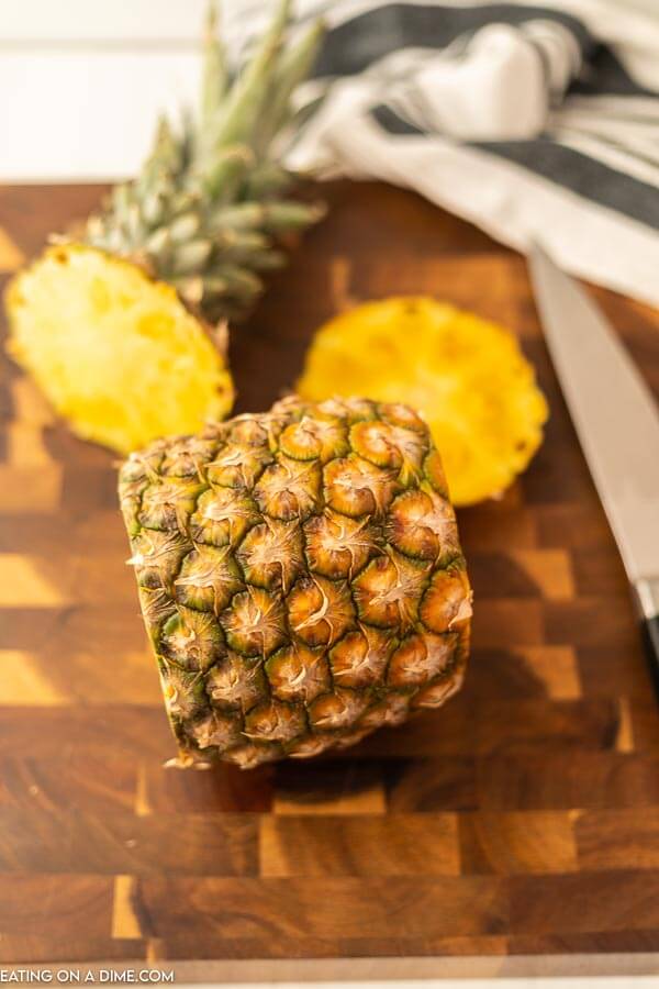 A whole pineapple with the  top and bottom cut off. 