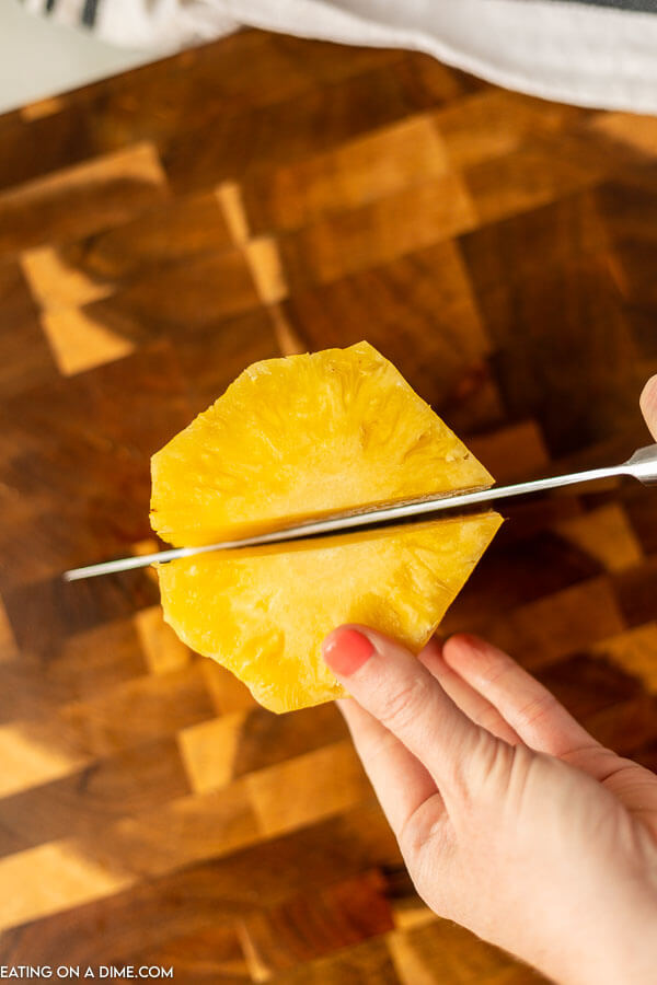 Cutting the pineapple in half