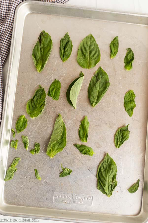 Basil leaves on a baking sheet