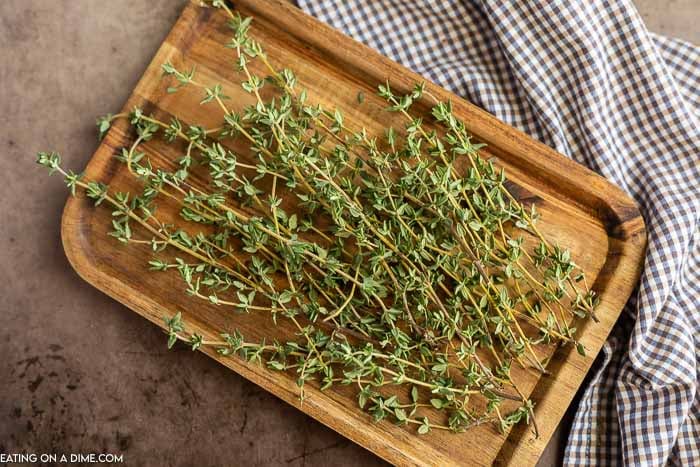 Fresh thyme stems on a cutting board.