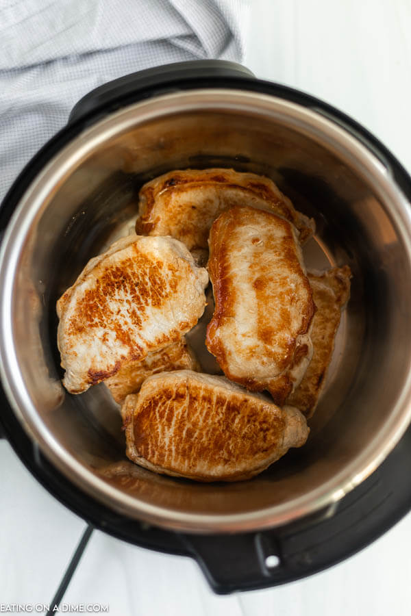 Close up image of pork chops browned in the instant pot. 