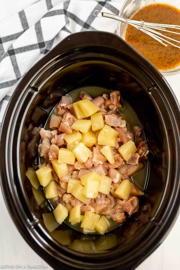Chicken and pineapple chunks in the slow cooker. 