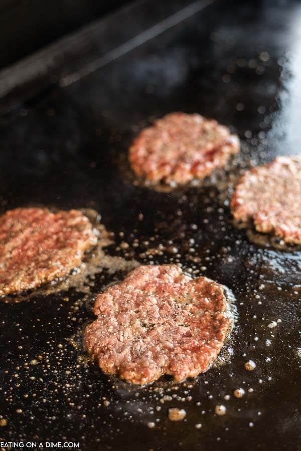 Burgers cooking on the grill. 